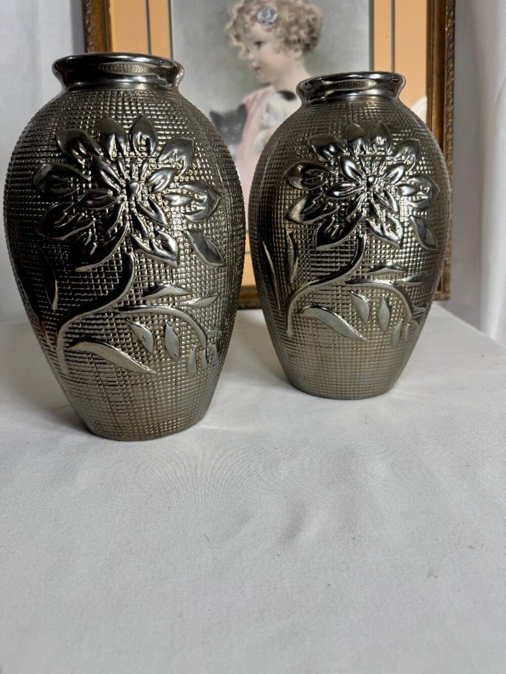 Vintage Pair of metallic silver-coated clay vases featuring a floral pattern